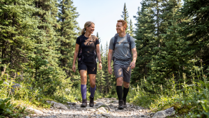 Man and woman wearing Sigvaris Bamboo compression stockings while hiking in nature