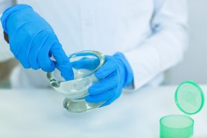 Pharmacist grinding medicine in mortar and pestle to be used when compounding